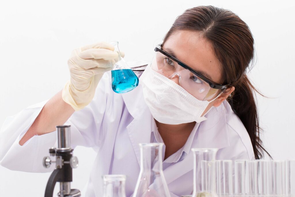 Chemist checking the chemical in the glassware