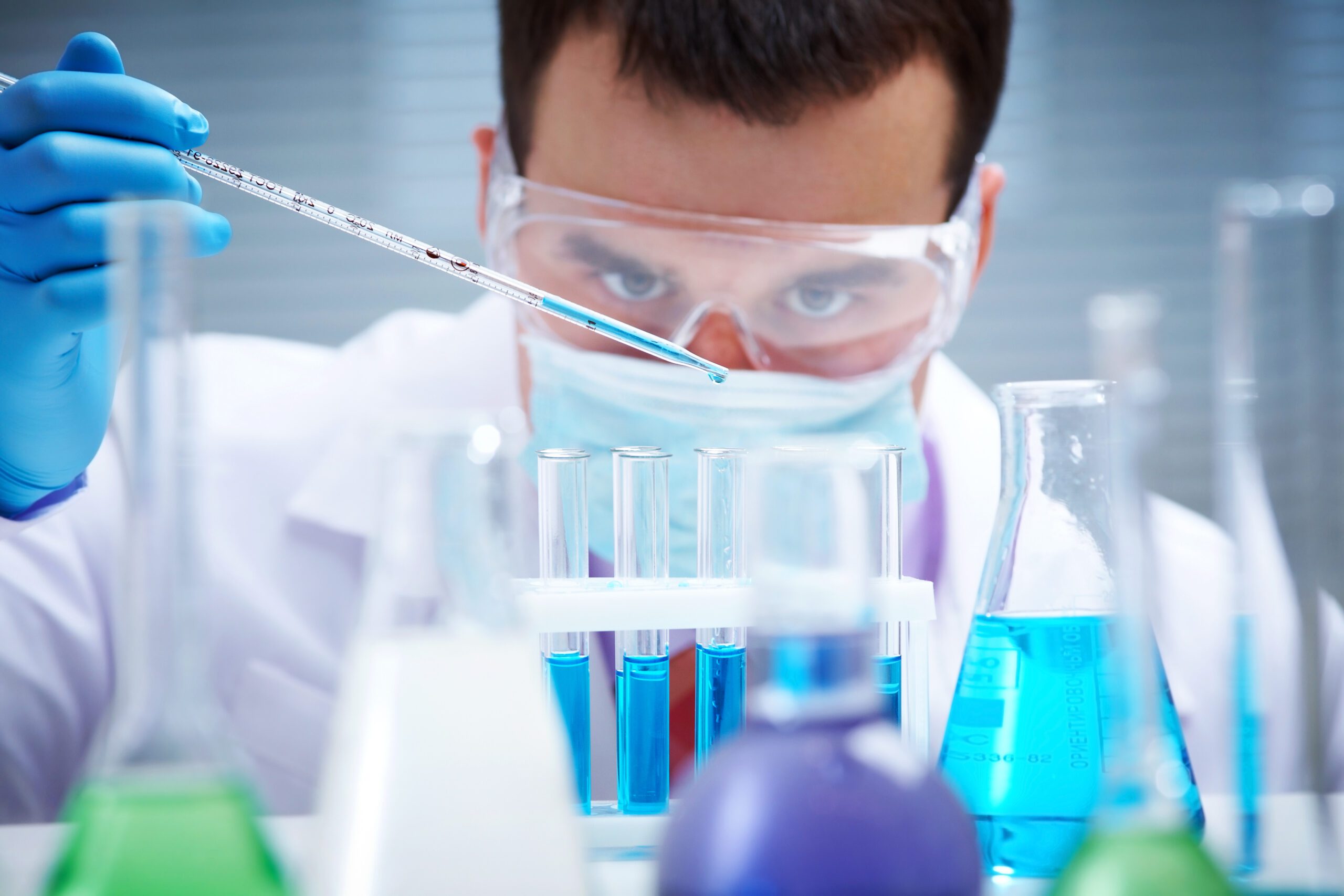 Man mixing chemicals in test tube